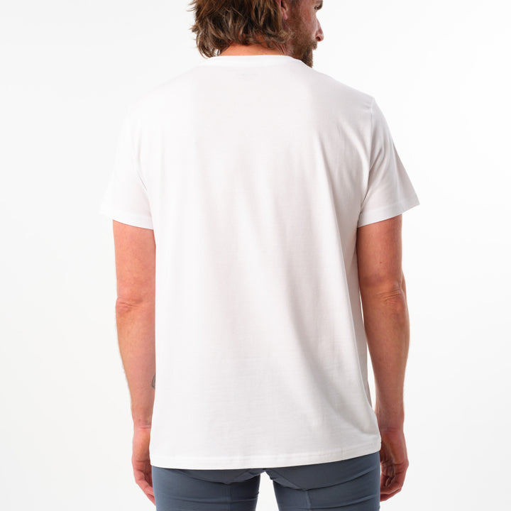 Person wearing a plain white t-shirt on a white background